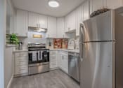 Thumbnail 1 of 40 - a modern kitchen with stainless steel appliances and white cabinets  at Danville Park, California, 94526