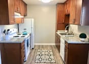 Thumbnail 14 of 25 - a kitchen with wooden cabinets and a white refrigerator at Element LLC, Sunnyvale, CA