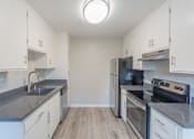 Thumbnail 1 of 25 - an empty kitchen with stainless steel appliances and white cabinets at Element LLC, Sunnyvale, CA, 94086