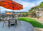 Thumbnail 6 of 25 - a patio with a table and chairs and an umbrella at Element LLC, Sunnyvale