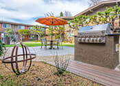 Thumbnail 4 of 25 - a patio with a grill and a table with an umbrella at Element LLC, Sunnyvale, CA