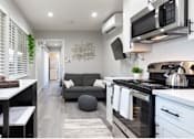 Thumbnail 18 of 25 - a small living room with a kitchen and a couch at Element LLC, Sunnyvale, 94086