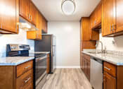 Thumbnail 12 of 25 - a kitchen with wooden cabinets and stainless steel appliances at Element LLC, Sunnyvale