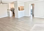 Thumbnail 16 of 31 - an empty living room and kitchen with a wood floor at The Flats on Addison, Sherman Oaks, 91423