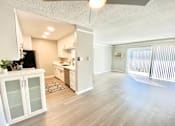 Thumbnail 5 of 31 - an empty living room and kitchen with a sliding glass door at The Flats on Addison, Sherman Oaks, CA