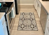 Thumbnail 7 of 31 - a kitchen with a rug in the middle of the floor at The Flats on Addison, Sherman Oaks California