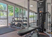 Thumbnail 2 of 31 - a gym with weights and cardio equipment and a window at The Flats on Addison, Sherman Oaks California