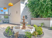 Thumbnail 8 of 31 - a fountain in a courtyard in front of a building at The Flats on Addison, Sherman Oaks