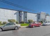 Thumbnail 22 of 39 - a building with cars parked in front of it at The Arches Apartments, California