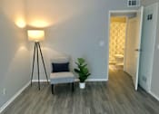 Thumbnail 4 of 19 - a living room with a chair and a potted plant  at The Marq Apartments LLC, Los Angeles, California