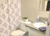 Thumbnail 5 of 19 - a bathroom with a toilet and a sink and a shower curtain  at The Marq Apartments LLC, Los Angeles