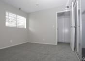 Thumbnail 6 of 19 - an empty bedroom with a closet and a window  at The Marq Apartments LLC, California