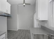 Thumbnail 7 of 19 - a kitchen with white cabinets and a ceiling fan  at The Marq Apartments LLC, Los Angeles, California