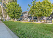 Thumbnail 7 of 18 - apartment community with grass and trees at BLVD Apartments LLC, Tarzana, CA 91356