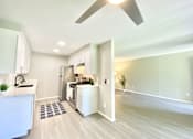 Thumbnail 17 of 18 - an open kitchen and living room with a ceiling fan at BLVD Apartments LLC, Tarzana California
