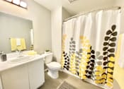Thumbnail 14 of 18 - a bathroom with a shower curtain and a sink and a toilet at BLVD Apartments LLC, Tarzana, CA 91356