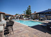 Thumbnail 7 of 44 - a swimming pool with chairs and umbrellas at The Bryant, California, 92887