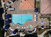 Thumbnail 5 of 44 - an aerial view of a swimming pool at a resort with umbrellas and chairs at The Bryant, California