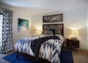 Thumbnail 10 of 44 - a bedroom with a bed and a blue rug at The Bryant, Yorba Linda, CA