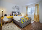 Thumbnail 15 of 44 - a bedroom with a bed and a desk at The Bryant, Yorba Linda