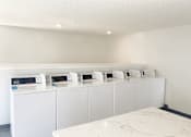 Thumbnail 16 of 39 - a bunch of microwaves are on display in a room at Latitude Apartments at Mission Valley, California, 92120