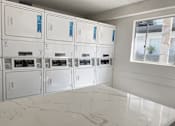 Thumbnail 15 of 39 - a bunch of white appliances in a room at Latitude Apartments at Mission Valley, San Diego