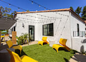 Thumbnail 4 of 27 - a backyard with yellow chairs and a white house at La Jolla Blue, San Diego