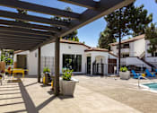 Thumbnail 26 of 27 - a patio with a white building and a swimming pool at La Jolla Blue, California