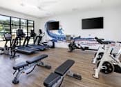 Thumbnail 2 of 27 - a gym with cardio equipment and a wall mural of the beach at La Jolla Blue, San Diego