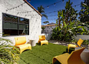 Thumbnail 5 of 27 - a backyard with yellow chairs and a green lawn at La Jolla Blue, San Diego, CA 92122