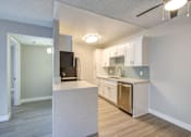 Thumbnail 15 of 27 - a renovated kitchen with white cabinets and stainless steel appliances at La Jolla Blue, San Diego