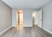 Thumbnail 17 of 27 - an empty living room with white walls and wood floors at La Jolla Blue, San Diego, CA 92122