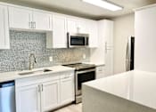 Thumbnail 1 of 27 - a kitchen with white cabinets and a counter top at La Jolla Blue, California