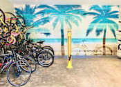 Thumbnail 6 of 27 - a group of bikes parked in front of a wall mural of a beach with palm at La Jolla Blue, San Diego, CA