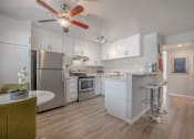 Thumbnail 18 of 24 - a kitchen with white cabinets and a ceiling fanat Napa Green Apartments LLC, Napa, 94559