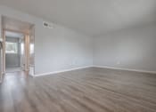 Thumbnail 19 of 24 - an empty living room with white walls and wood floors at Napa Green Apartments LLC, Napa California