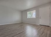 Thumbnail 17 of 24 - an empty living room with wood floors and a window at Napa Green Apartments LLC, Napa, CA 94559