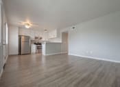 Thumbnail 16 of 24 - the living room and kitchen of an apartment with a wood floor at Napa Green Apartments LLC, California, 94559