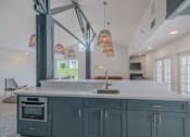 Thumbnail 23 of 24 - a large kitchen with blue cabinets and a white counter top at Napa Green Apartments LLC, Napa