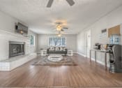 Thumbnail 19 of 45 - Living room with a fireplace at Ocean Villas Apartments, Oxnard, California