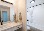 Thumbnail 14 of 83 - A bathroom with a white sink and a white bathtub at Summerwood Apartment , Santa Clara, CA