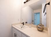 Thumbnail 13 of 83 - A bathroom with a white sink and a mirror at Summerwood Apartment , Santa Clara, California
