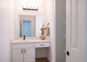 Thumbnail 15 of 83 - A bathroom with a white vanity and a mirror above it at Summerwood Apartment , Santa Clara, 95050
