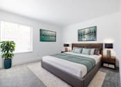 Thumbnail 6 of 83 - A bedroom with a large bed and two pictures on the wall at Summerwood Apartment , California
