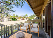 Thumbnail 5 of 83 - A wooden balcony with two chairs and a table at Summerwood Apartment , Santa Clara, CA
