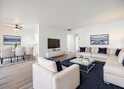 Thumbnail 3 of 83 - A modern living room with white furniture and a flat screen TV at Summerwood Apartment , Santa Clara