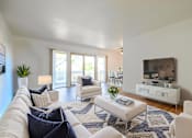 Thumbnail 1 of 83 - A living room with white furniture and a flat screen TV at Summerwood Apartment, Santa Clara, CA, 95050