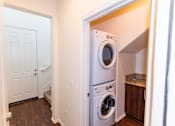 Thumbnail 3 of 45 - a washer and dryer in a laundry room with a white door at The Vines at Riverpark, LLC, California, 93036