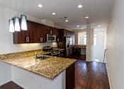 Thumbnail 34 of 45 - a kitchen with a granite counter top and a at The Vines at Riverpark, LLC, California, 93036