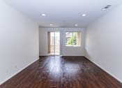 Thumbnail 45 of 45 - an empty living room with white walls and wood floors at The Vines at Riverpark, LLC, California, 93036